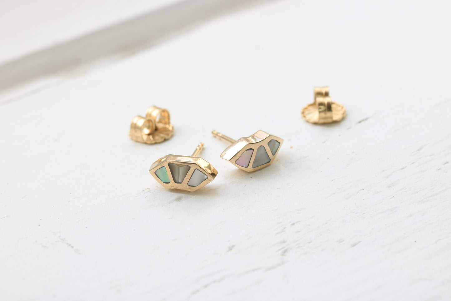14k yellow gold fan studs with California red abalone inlay on white background