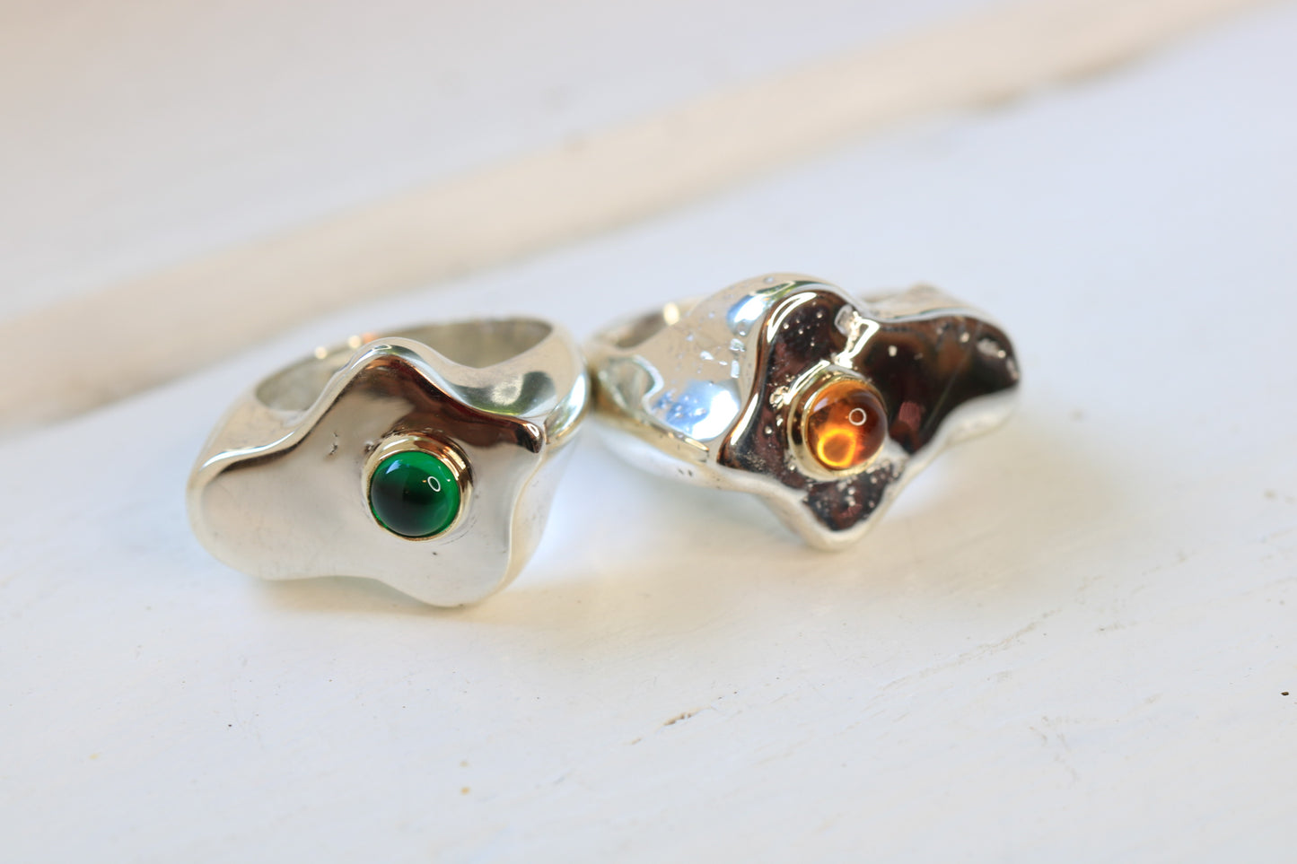 sterling silver fried egg shape sand cast rings with an emerald or citrine cabochon set in 14k gold