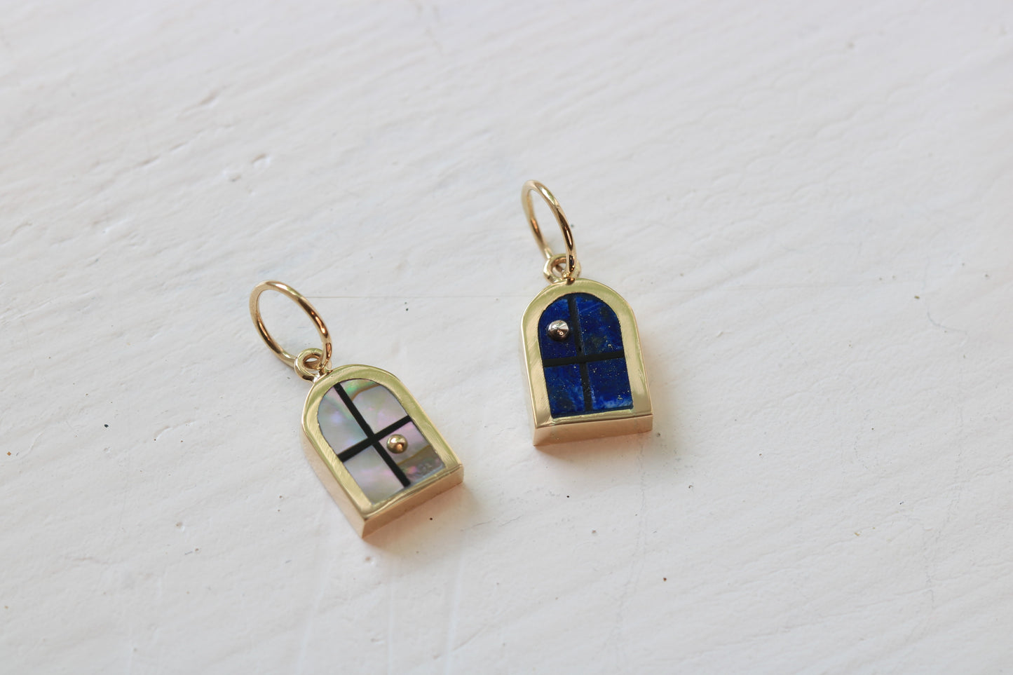 window charms in 14k yellow gold with abalone inlay and 14k gold sun or lapis lazuli inlay and sterling silver moon on white background