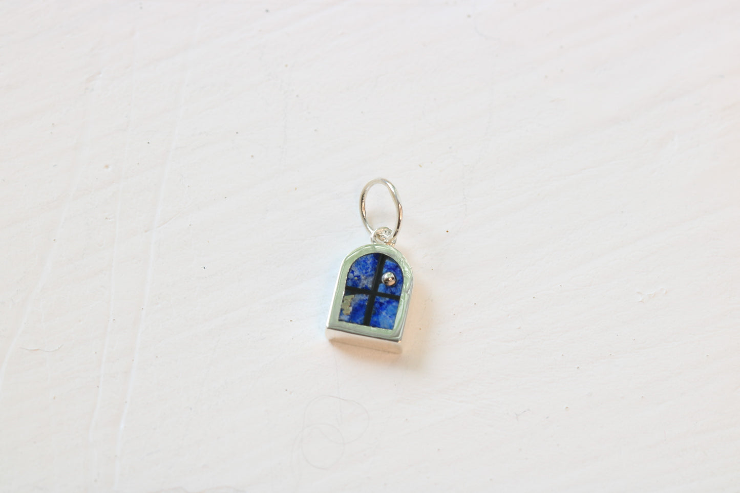 window charm in sterling silver with lapis lazuli inlay on white background