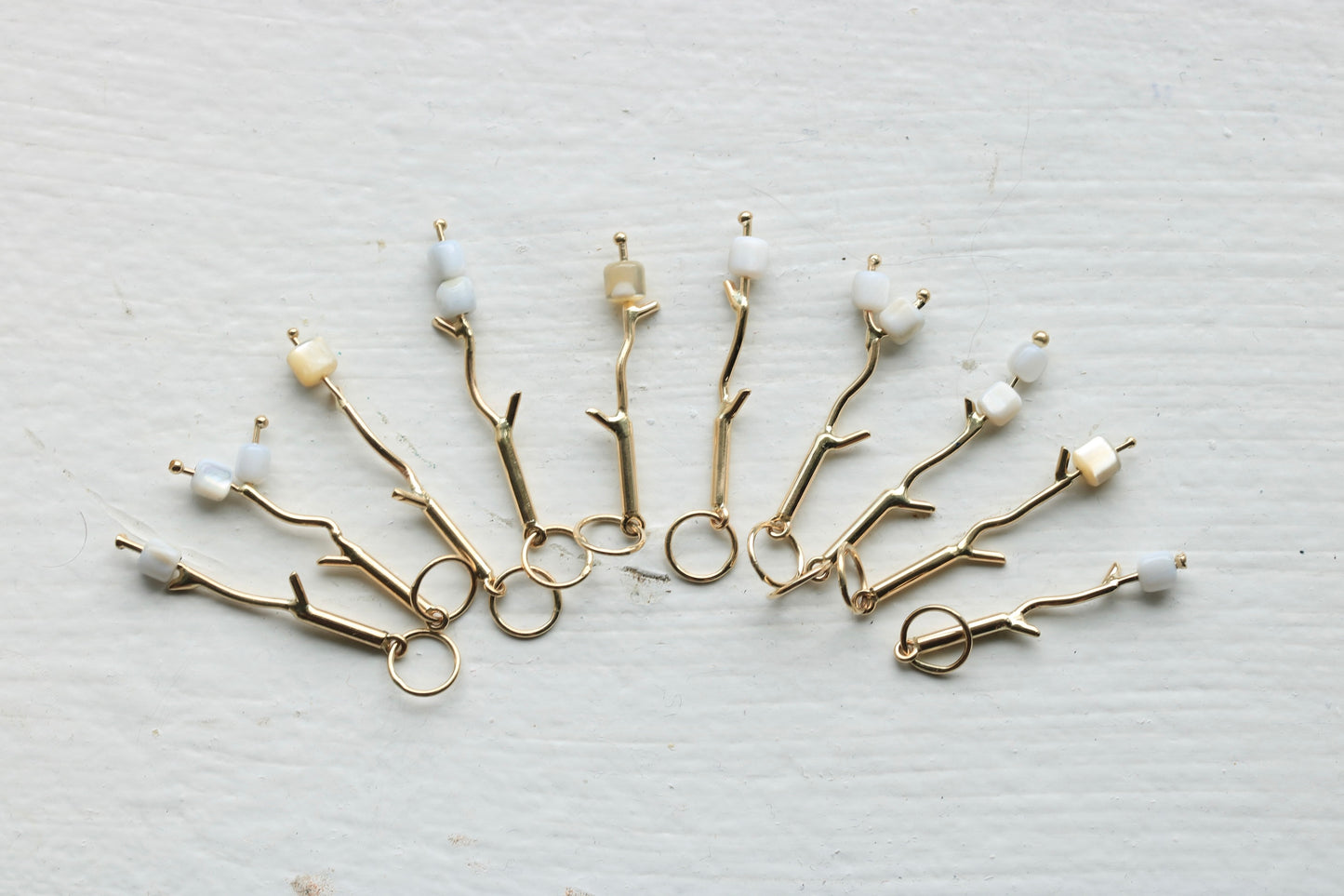 14k yellow gold marshmallow charms with mother of pearl beads.