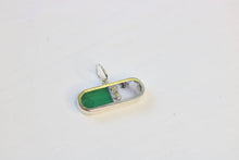 Load image into Gallery viewer, pill shaped sterling silver charm inlaid with chrysoprase and merlinite and an xo descriptor
