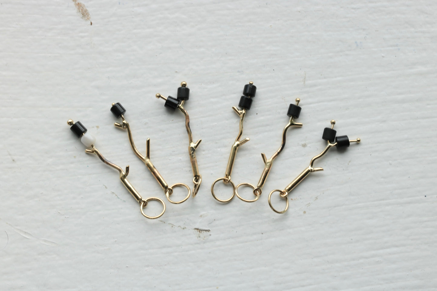 14k yellow gold branches with black onyx burnt marshmallow beads.