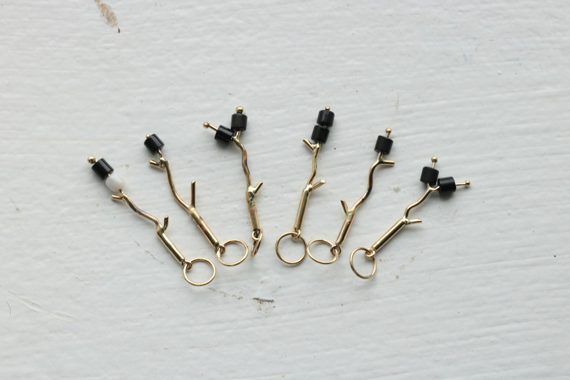 14k yellow gold branches with black onyx burnt marshmallow beads.