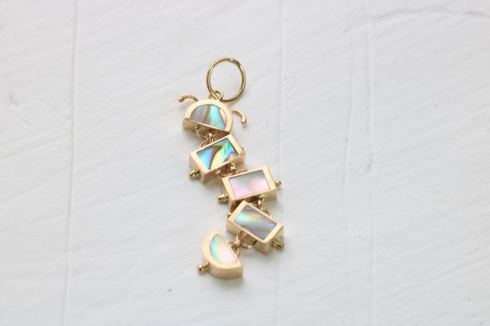 14k gold caterpillar inlaid with abalone on white background
