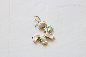 14k gold caterpillar in five pieces of inlaid abalone on white background
