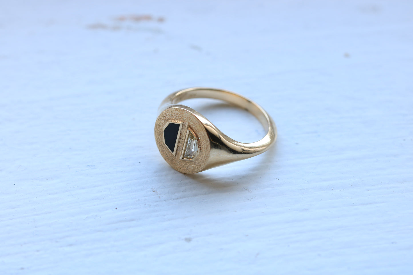 14k gold ring signet with a half octagon black stone inlay and half octagon natural diamond.
