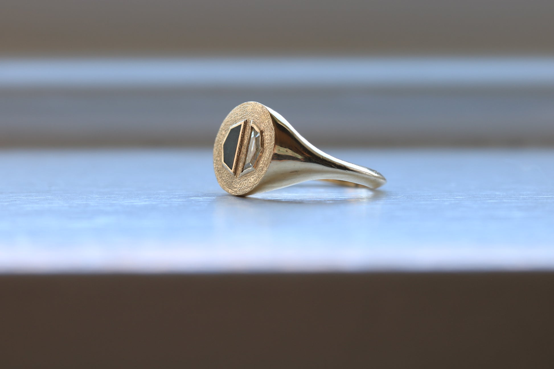 14k gold ring signet with a half octagon black stone inlay and half octagon natural diamond.