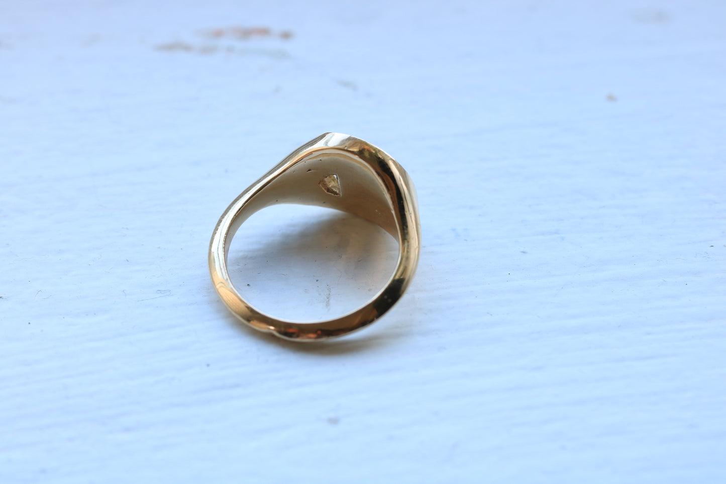 14k gold ring signet with a half octagon black stone inlay and half octagon natural diamond.