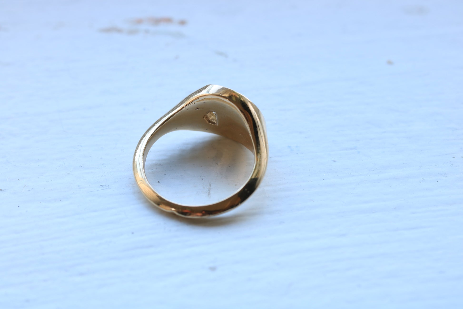 14k gold ring signet with a half octagon black stone inlay and half octagon natural diamond.