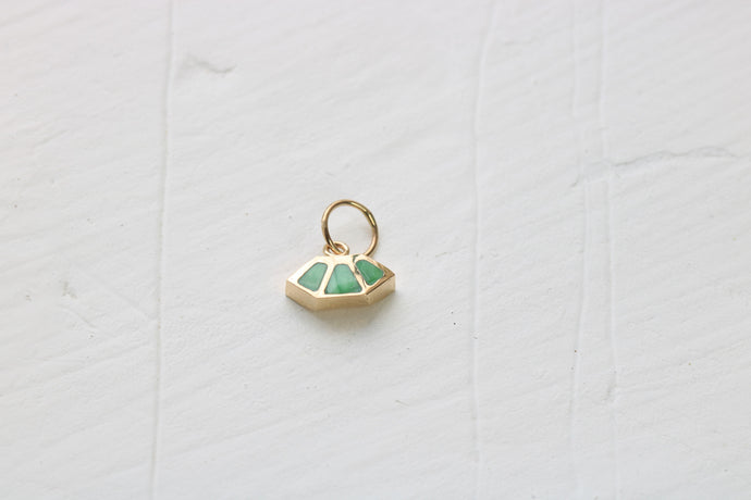 14k gold fan charm inlaid with green variscite sitting on white background