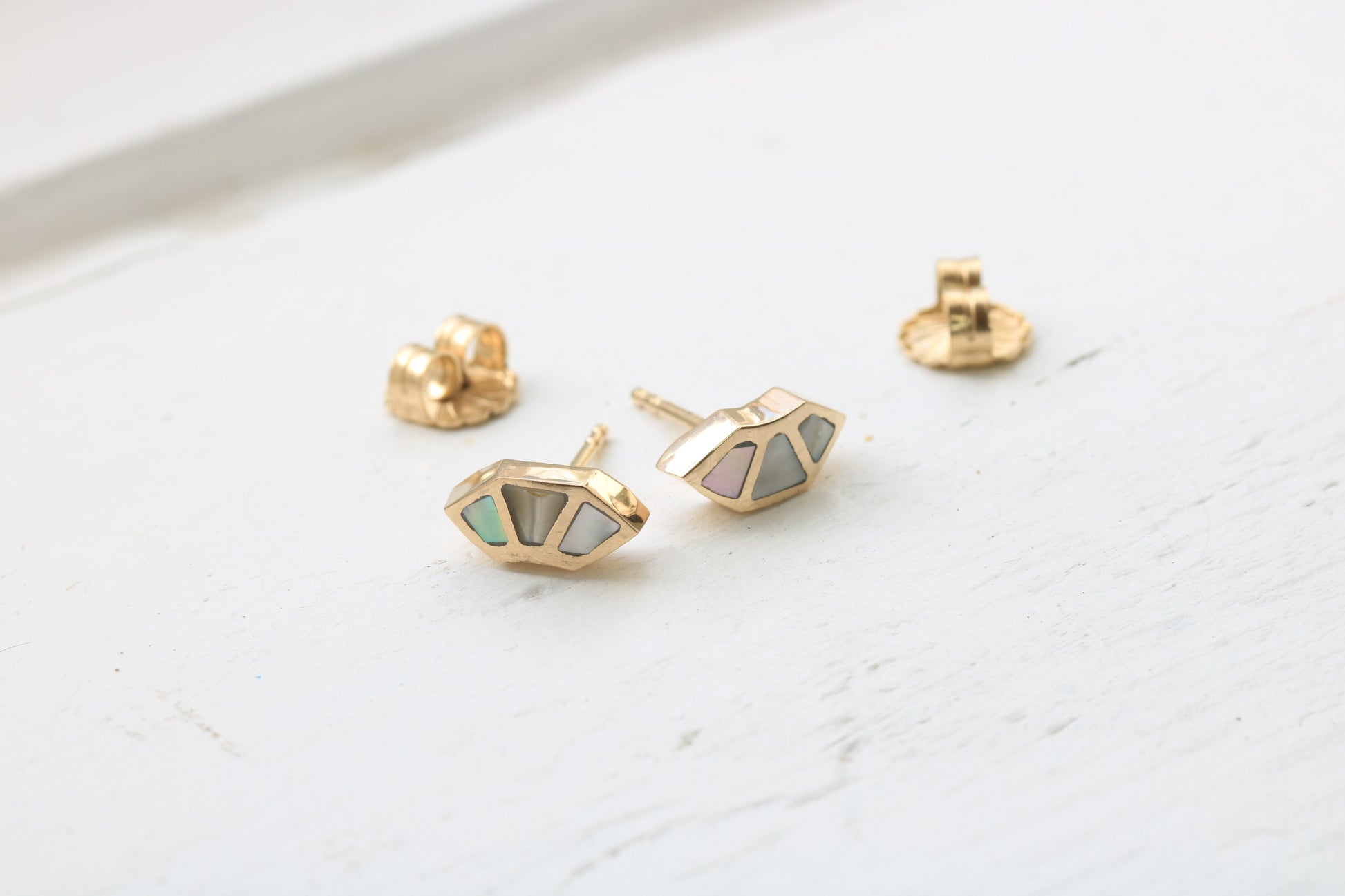 14k yellow gold fan studs with California red abalone inlay on white background