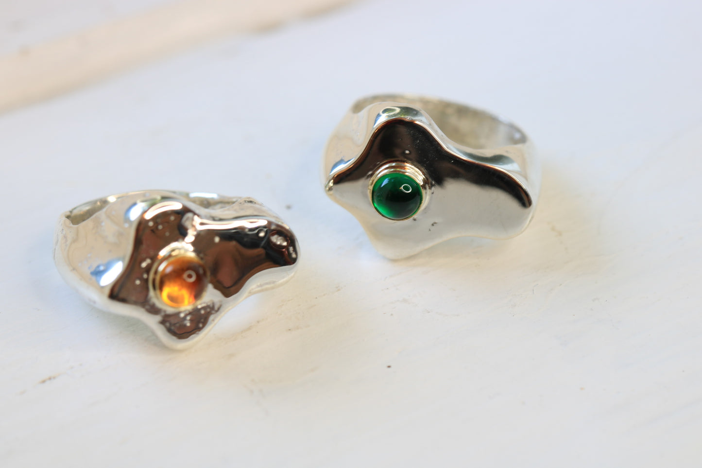 sterling silver fried egg sand cast rings set with a citrine or emerald cabochon in 14k yellow gold.