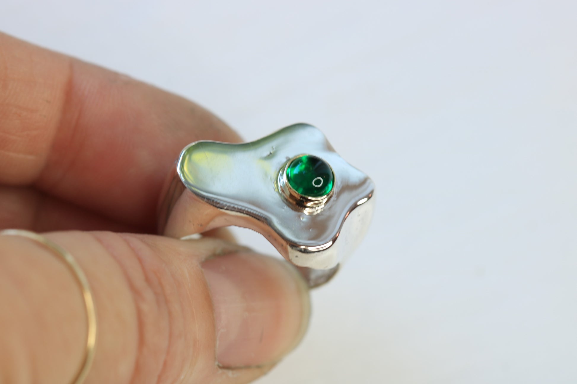 sterling silver sand cast fried egg ring with an emerald cabochon set in 14k yellow gold.