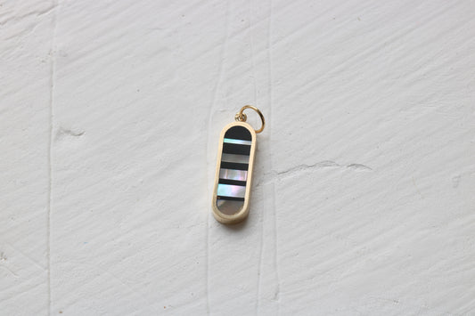 infinity charm in 14k yellow gold with black petrified wood and california red abalone inlay
