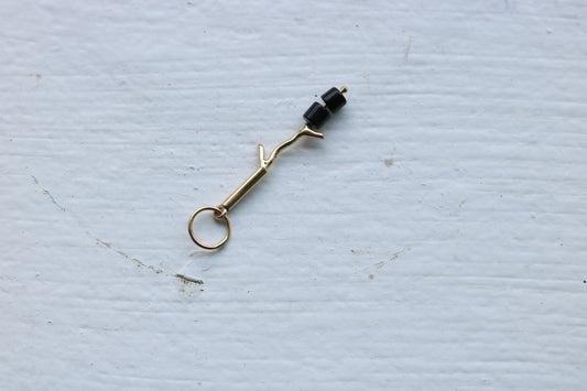 14k yellow gold branch with two onyx marshmallow beads.