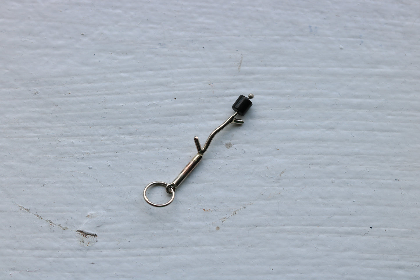 14k white gold branch with one onyx marshmallow bead.