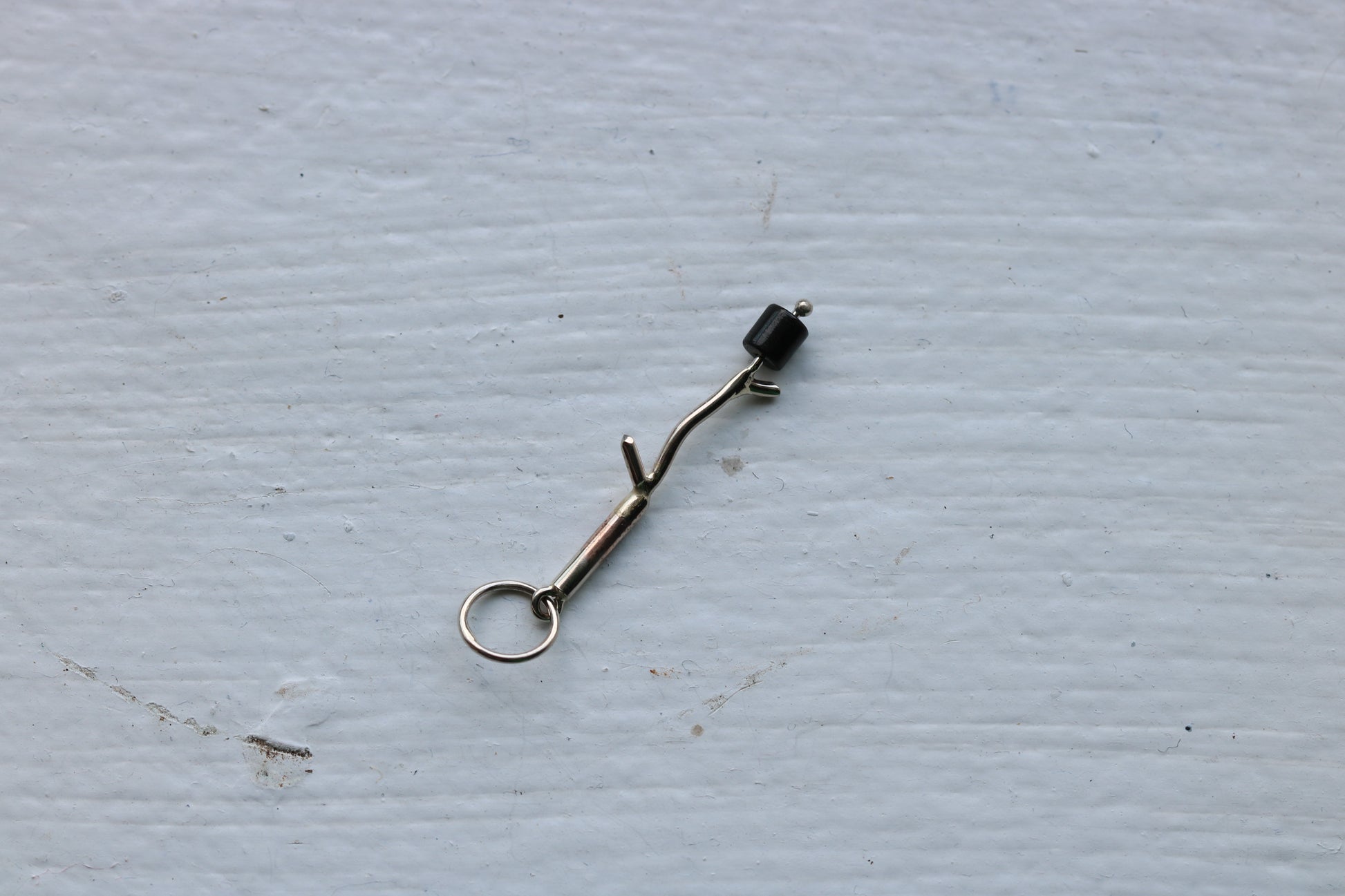 14k white gold branch with one onyx marshmallow bead.