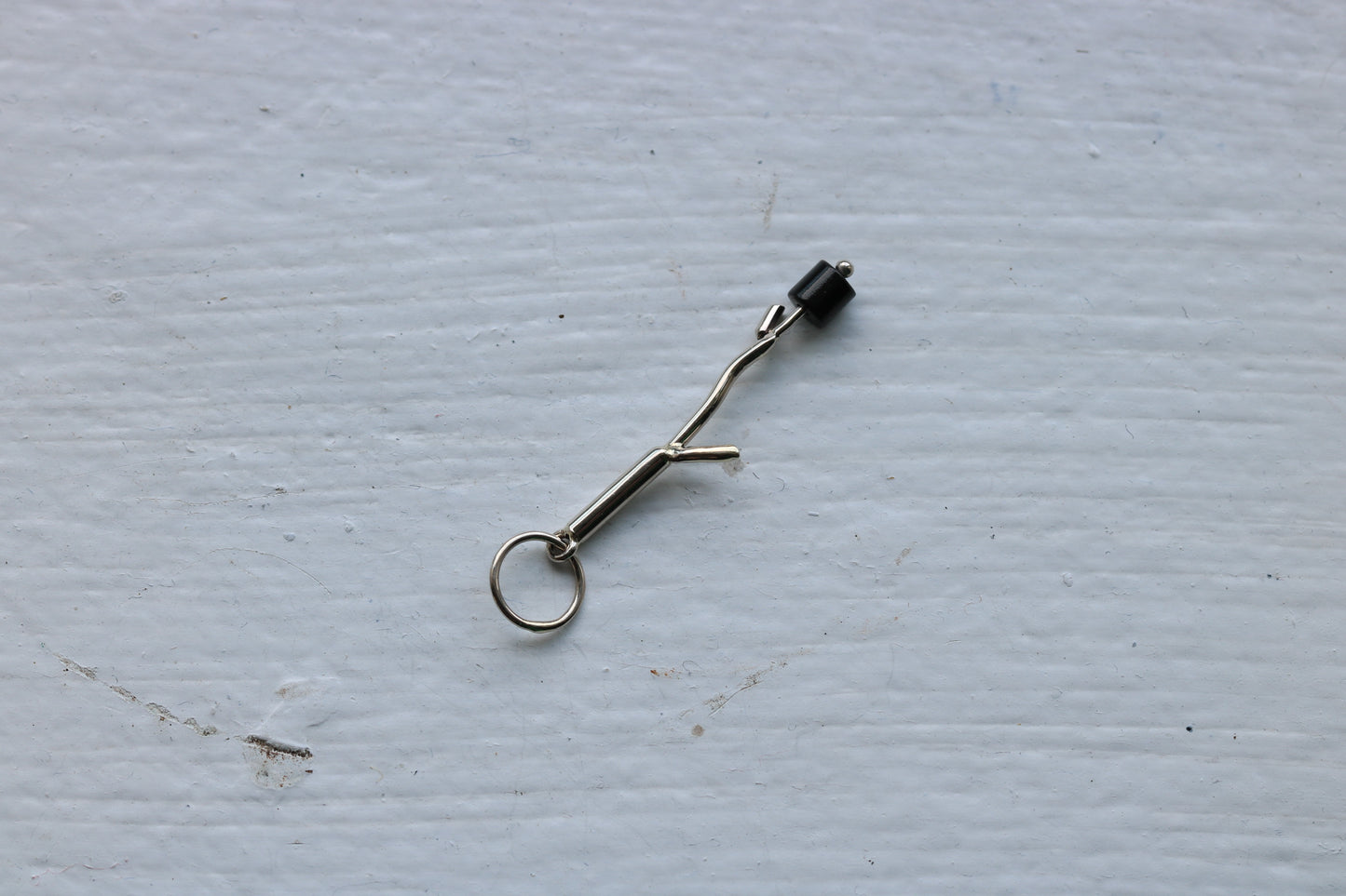 14k white gold branch with one  onyx marshmallow bead.