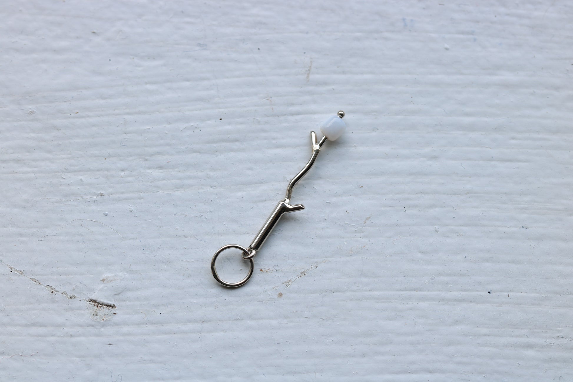 14k white gold branch with mother of pearl marshmallow bead.