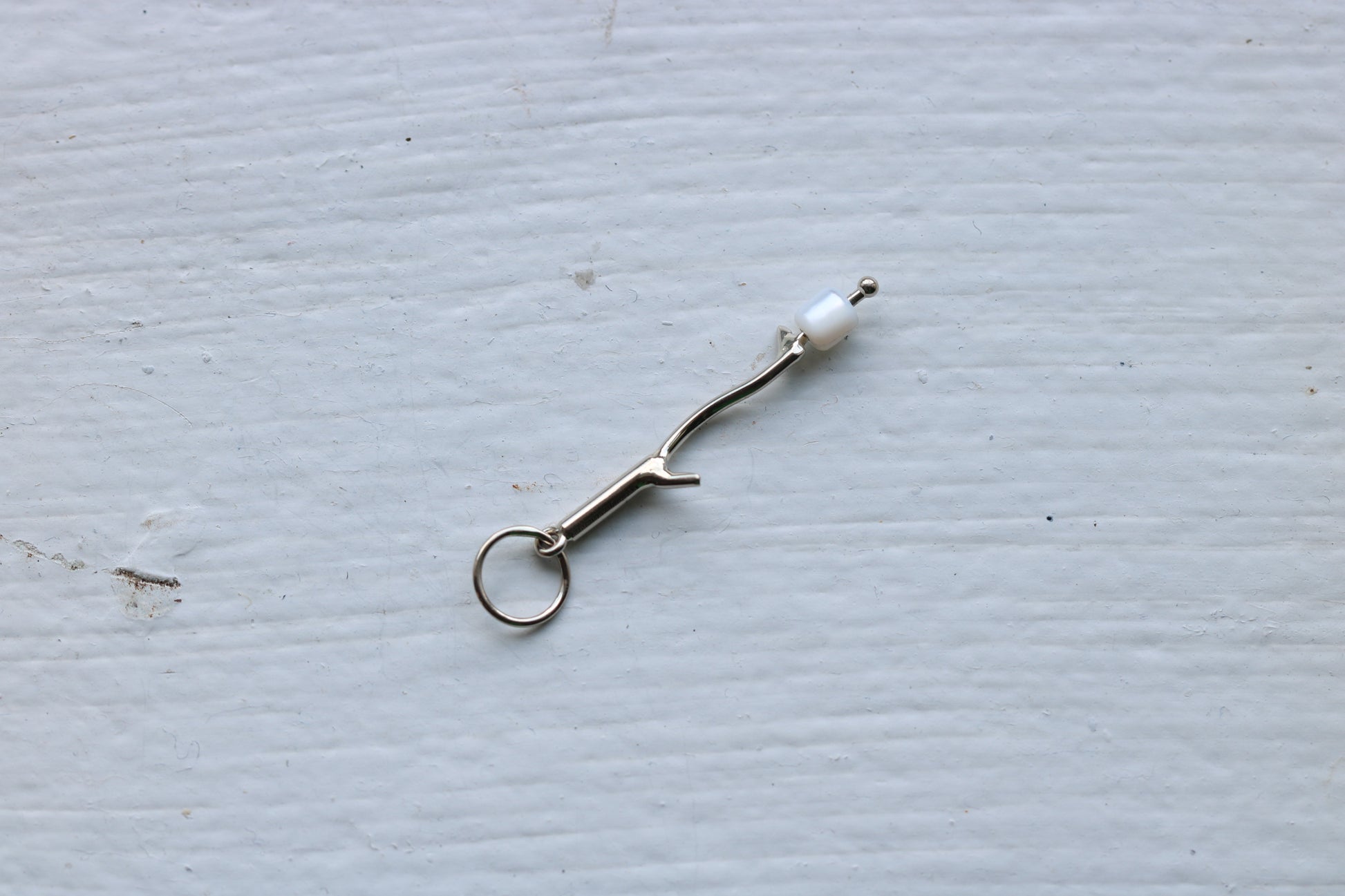 14k white gold branch with mother of pearl marshmallow bead.