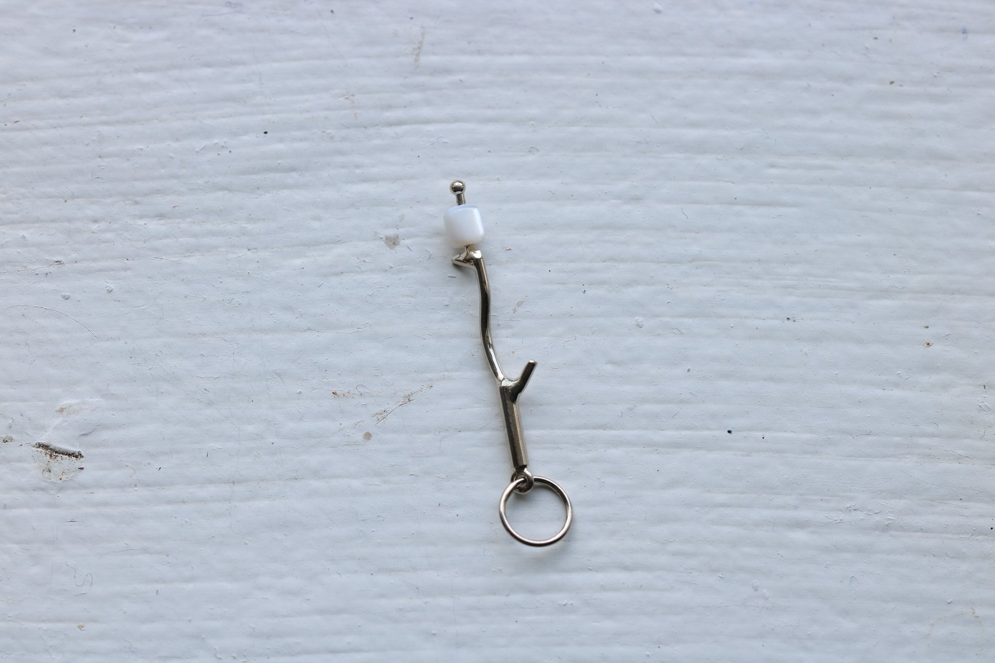 14k white gold branch with mother of pearl marshmallow bead.