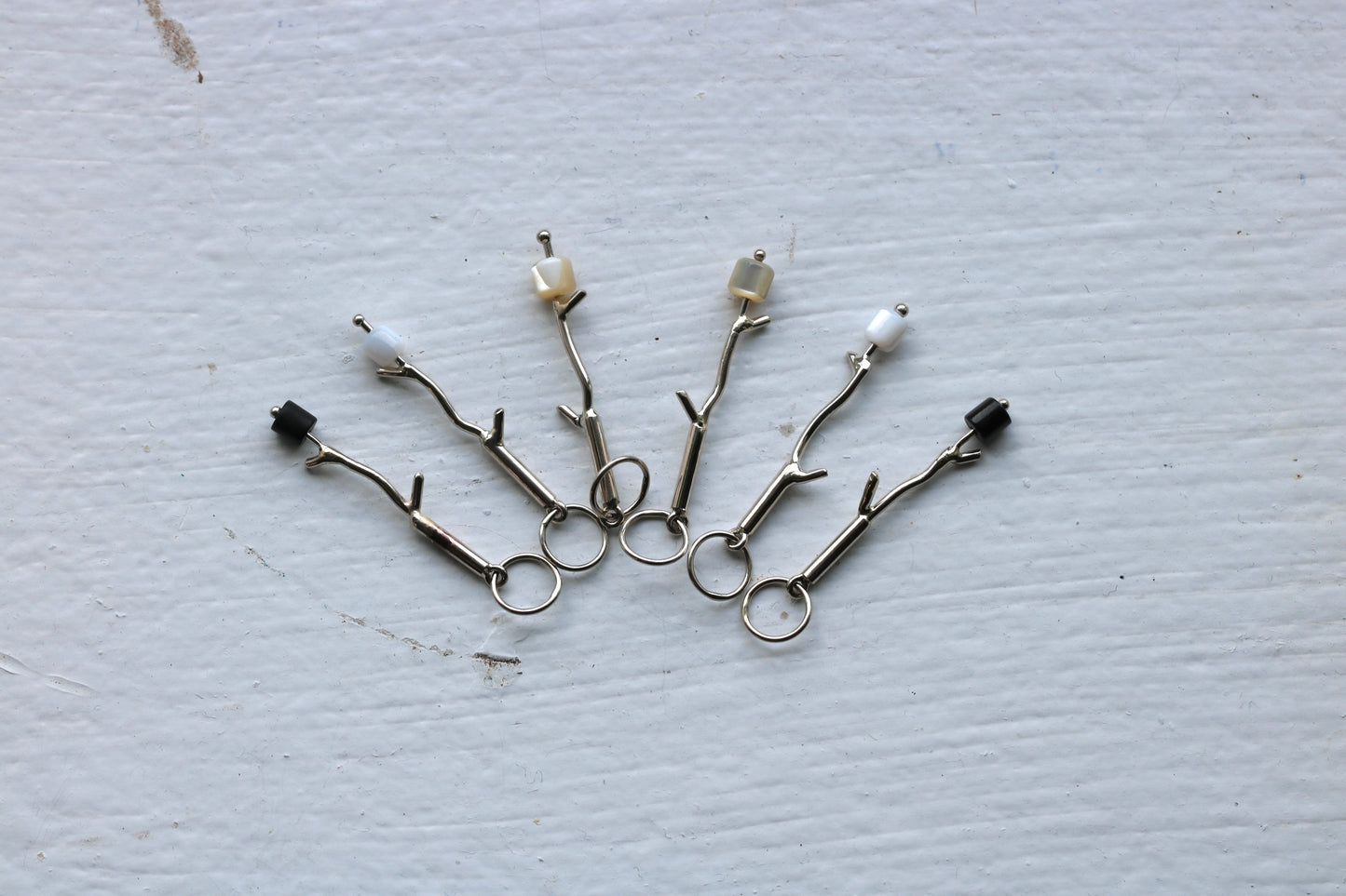 14k white gold branches with either onyx or mother of pearl marshmallow bead.