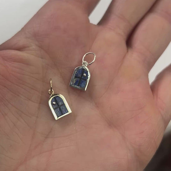 silver window charms in hand