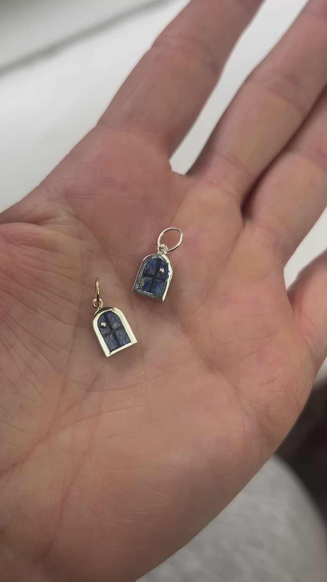 silver window charms in hand