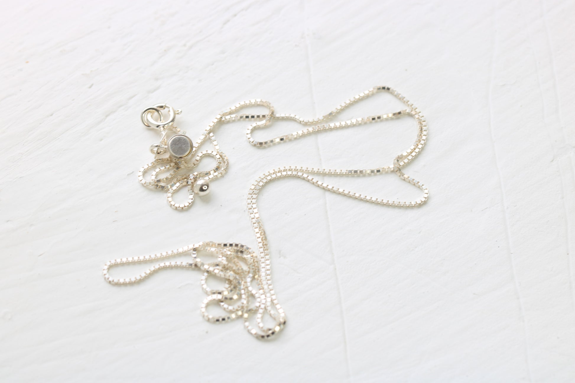 sterling silver box chain on white background