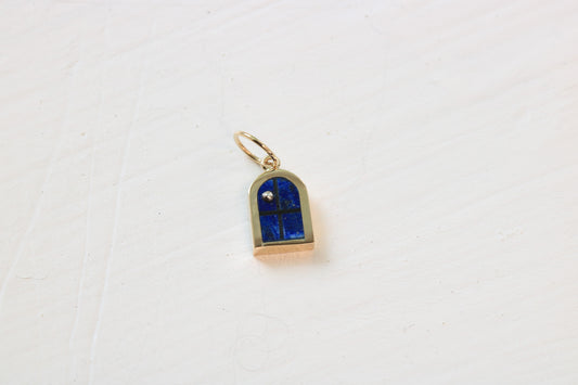 window charm in 14k gold on white background with lapis lazuli inlay