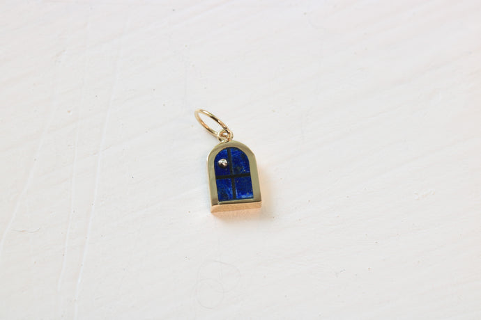 window charm in 14k gold on white background with lapis lazuli inlay