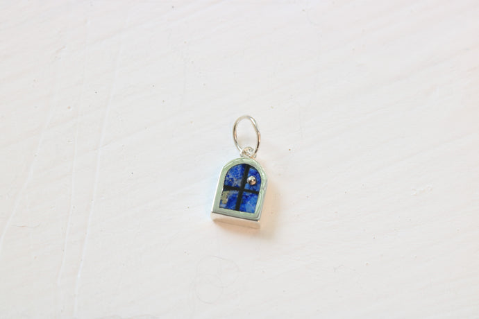 window charm in sterling silver with lapis lazuli inlay on white background